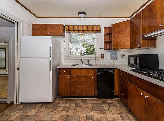 Kitchen window overlooks rear patio and yard.