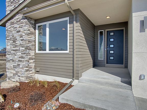 Covered Entry Photo representing home to be built and may demonstrate optional features