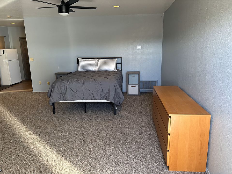 Front door look toward bed, dresser, and nightstands