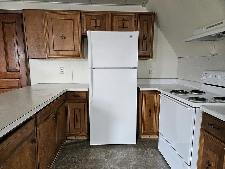 Kitchen has fridge and stove