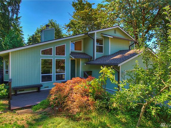 This view shows the front Trex deck with a bench to sit, relax and enjoy the flowers.