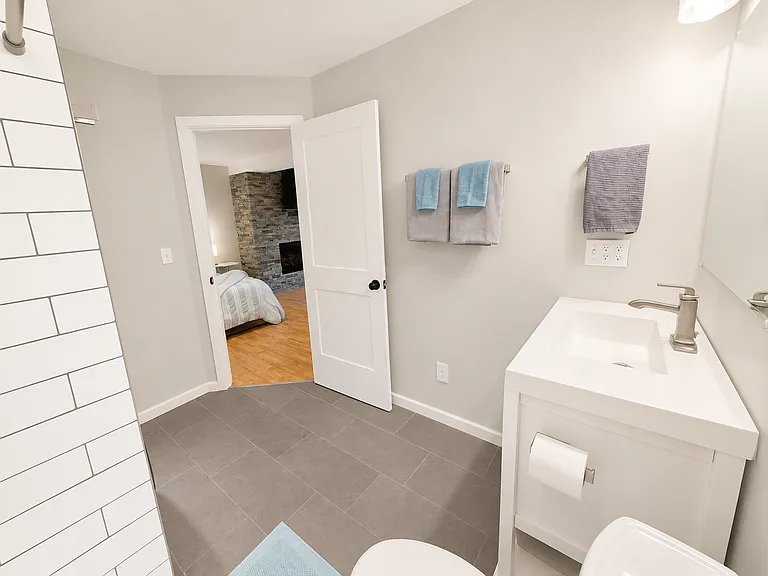 Spacious Laundry Room with New Samsung Washer and Dryer - Third Bathroom with Large Tile Shower