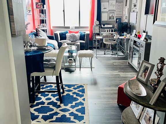 Walls are now a neutral gray color and kitchen is blue.