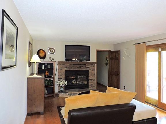 Cozy family room with wood burning fireplace walks out to deck.