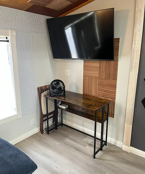 Desk with foldable chair and desk top fan.