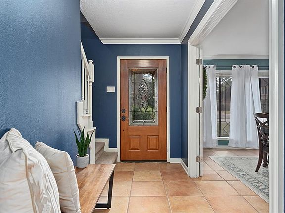 Greet guests in style through your wooden-door with in-laid glass into the spacious foyer. A step inside reveals beautiful tile floors & custom crown molding throughout.