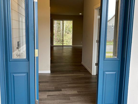 Entry way with beautiful laminate flooring that looks like hardwood.