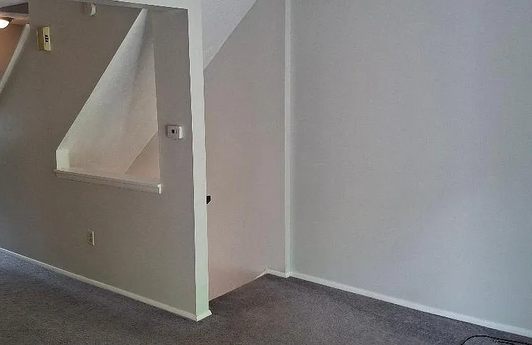 Stairs from garage to First floor Living area, including Kitchen, Powder Room, Dining Room/Living Room combination, 2 closets, and access to private deck.