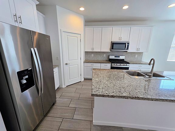 Huge island with lots of counter space and overhang for seating. Large walk in Pantry.