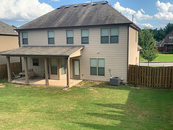 Back of house from top of large fenced yard, awesome Covered porch is shaded in the afternoons.