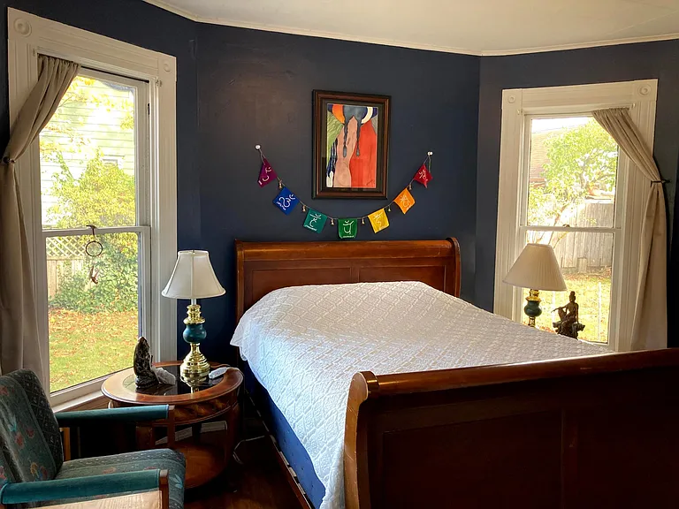 Each of these side windows lets in lots of light (these windows have been replaced with new double pained vinyl, same sized windows). There is also a window air conditioner and heater units for this room.