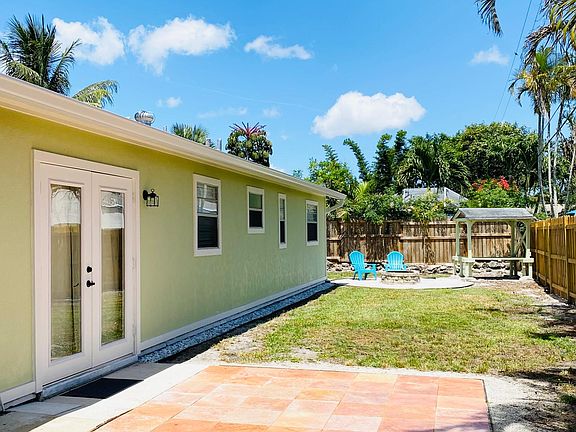 Large backyard for four-legged friends. A covered sitting area sits in the corner for escape from the summer sun and rain.