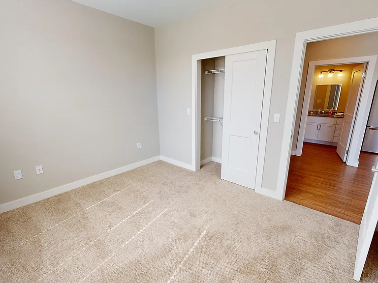 A cozy second bedroom with a full-size closet and plenty of room to make it your own.