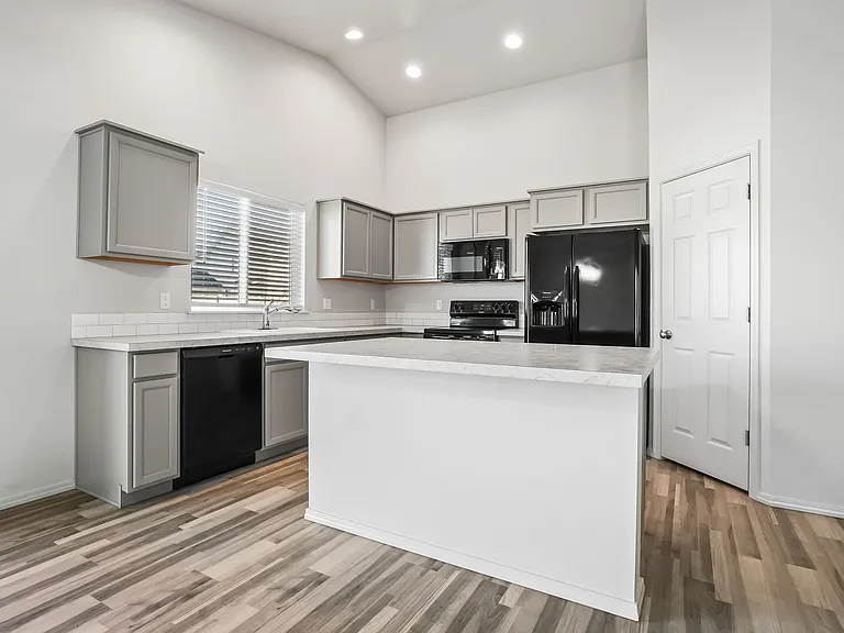 Island Kitchen with walk in pantry and vaulted ceilings