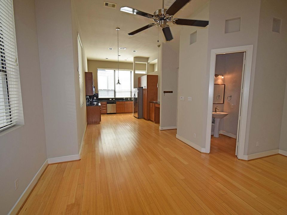 Large Living Room with Large Windows, Patio and Powder Room. Bamboo flooring throughout 2nd floor