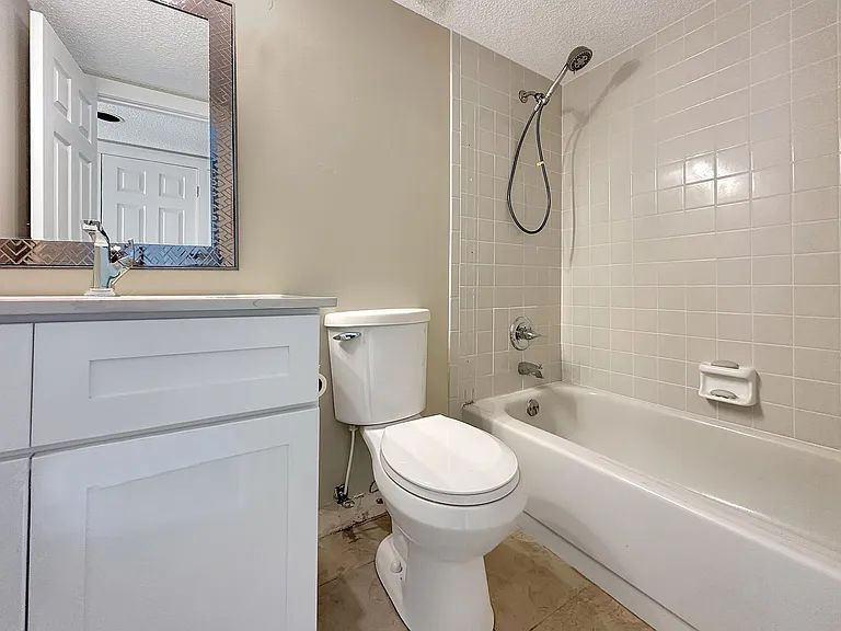 Main bathroom located off the hallway and living area.