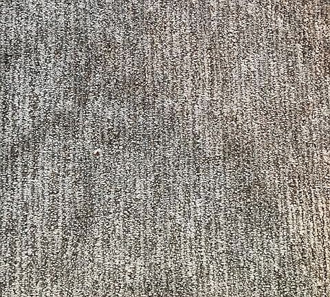The carpet has variegated yarns & feels soft & nice to the touch. It will go beautifully with whatever color scheme you put with it.