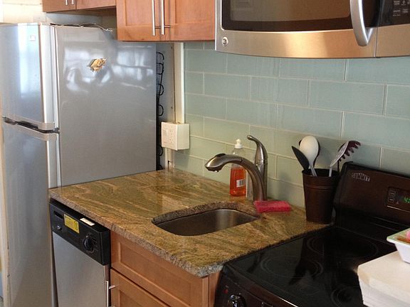 fully stocked newer kitchen with granite and stainless