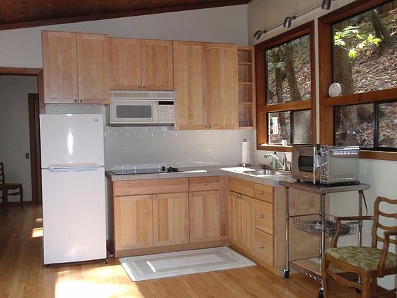 Kitchen area with hard wood floors, 3 skylights and new cabinets