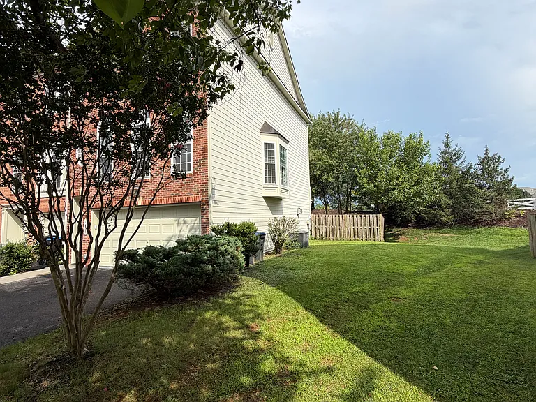 Side yard view toward the fenced in backyard