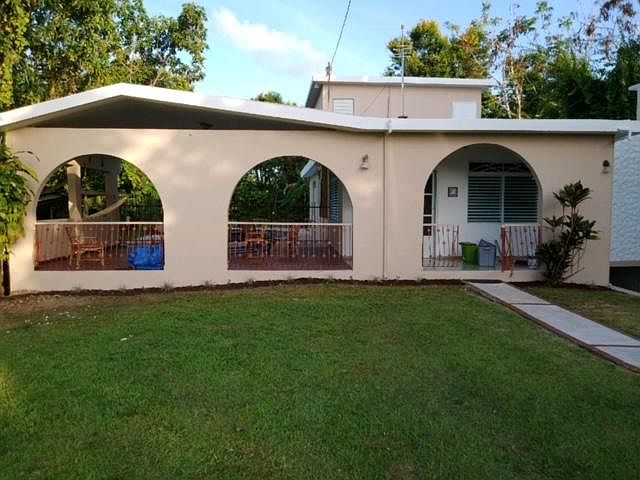 Front of the house shows the open terrace and main entrance