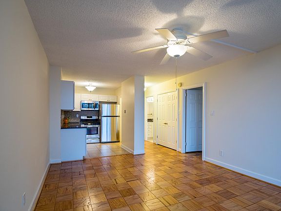 Living area with renovated hardwood and with view of kitchen