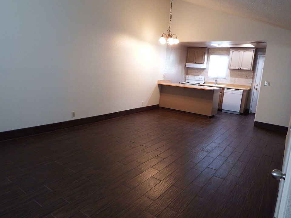 View into the large combination living room and dining room from the front entry door.
