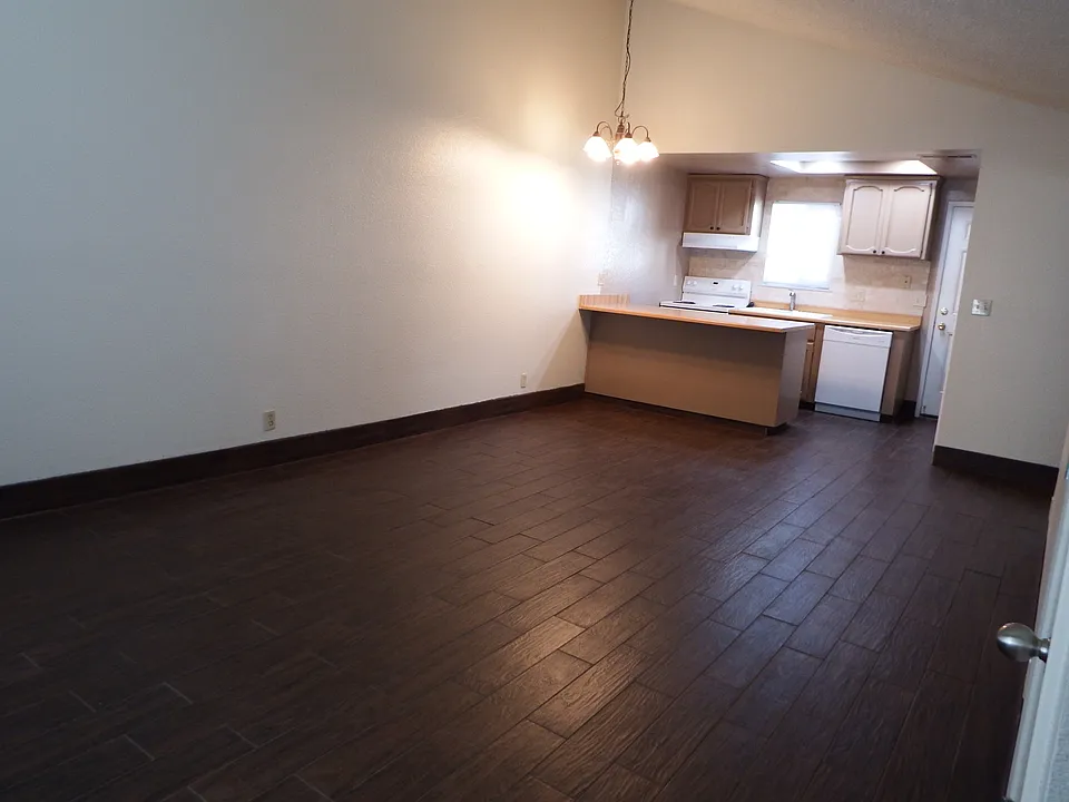 View into the large combination living room and dining room from the front entry door.