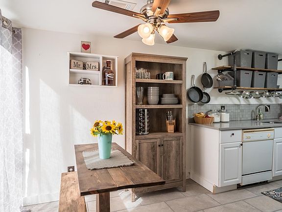 Kitchen has been updated with Quartz countertops, cabinets, tile floor, backsplash, paint and storage shelves.