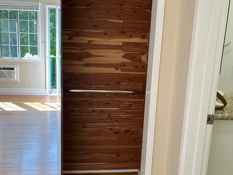 MIRRORED CEDAR LINED CLOSET W/ DOUBLE POLES