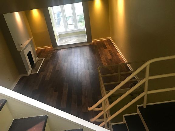 View of main living room and front windows from staircase