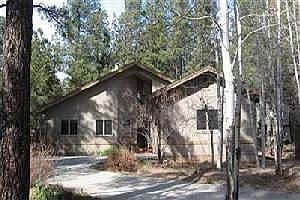 Wooded lot with pines and aspens in the front yard