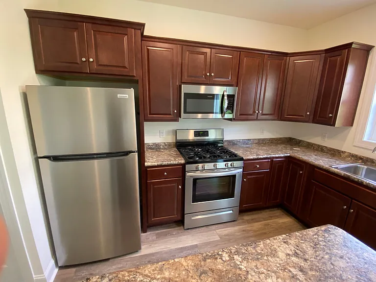 Kitchen features brand name gas stove and stainless steel appliances