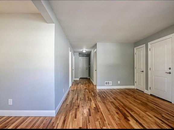 Other view of entrance, coat closet and living room
