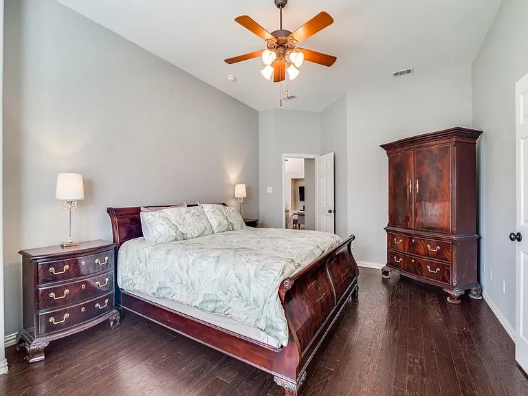 Primary bedroom w hardwood floors.