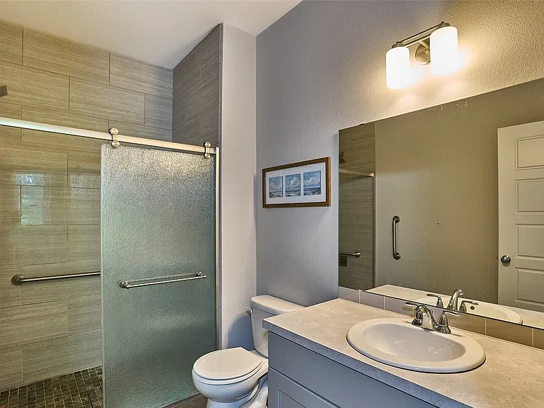 ADA accessible bathroom with roll-in shower attached to the bedroom on the main floor.