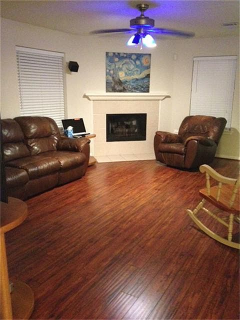 Family Room with Gas Log Fireplace, Beautiful Wood Laminate Flooring and loads of windows.