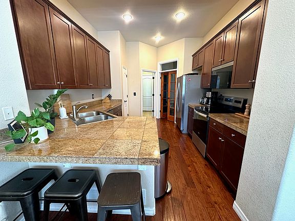 Kitchen w/ attached laundry and garage access. French doors lead to Office