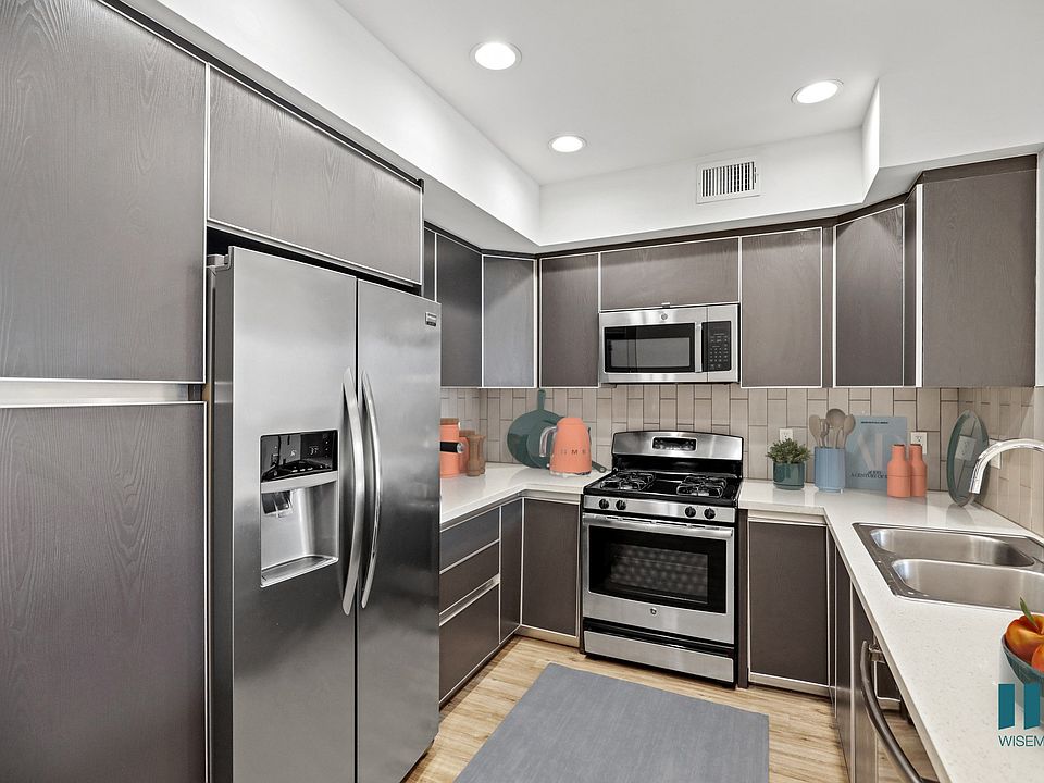Full-Size Kitchen with Stainless Steel Refrigerator, Stove, Microwave Oven, and Dishwasher