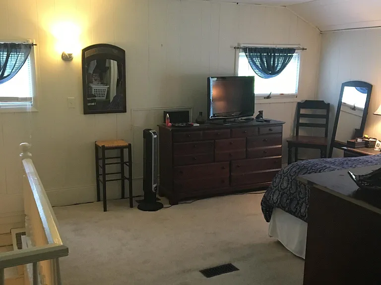 bedroom shown with previous tenants furniture