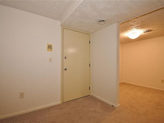 This is the entry door as seen from within the unit. New wall to wall carpeting installed in 2014.