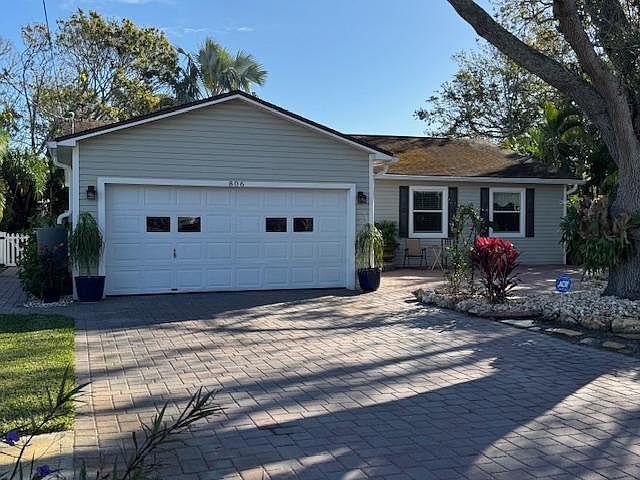 Front with paver driveway to front porch