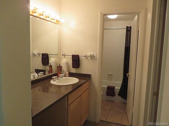 Bathroom with tile flooring and separate vanity area with new maple cabinet and Quartz countertop