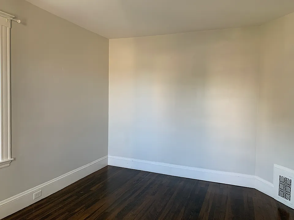 The other end of the living room which can fit a sectional couch