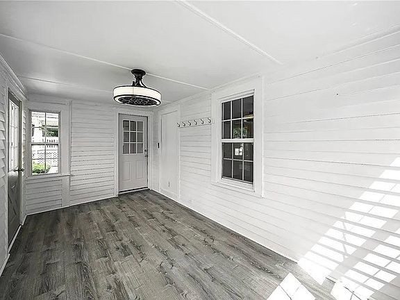 Sunroom with a view of the door into the main house