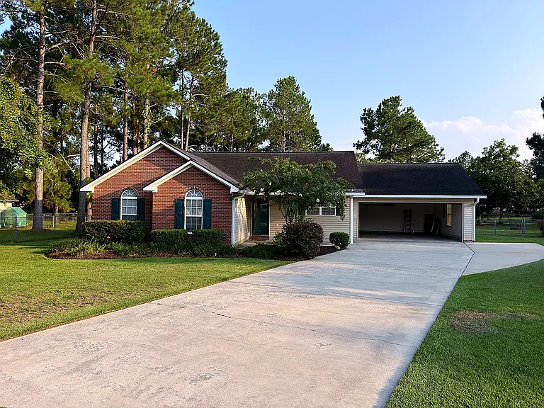 Welcoming front exterior with brick accents and an attached garage
