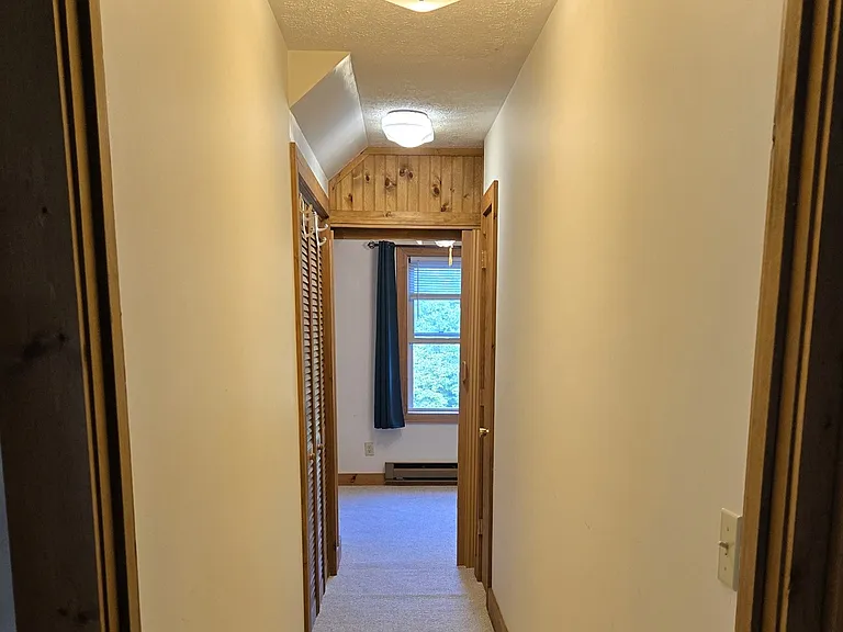 Upstairs hall leading to bonus room. Washer/Dryer in alcove to left