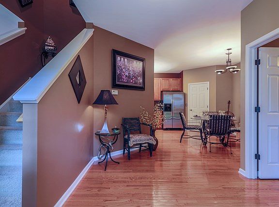 Large foyer with beautiful hardwood flooring.