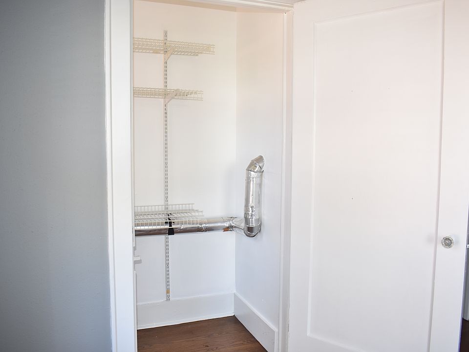Oversized walk in closet with shelving for storage.