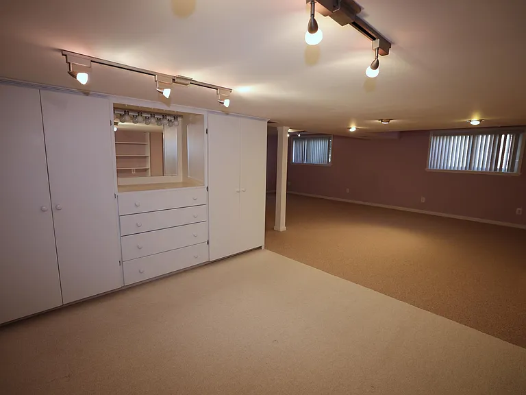Lower level has a dresser with mirror and closets, could be used as a sleeping area.